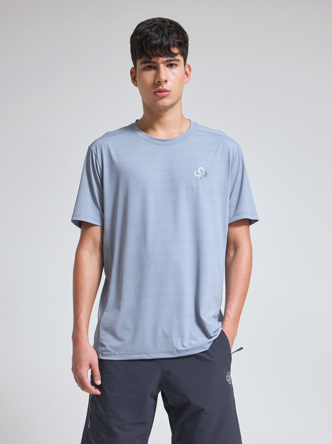 Man wearing Infinito’s sweat-wicking, lightweight performance tee engineered for everyday comfort and active movement