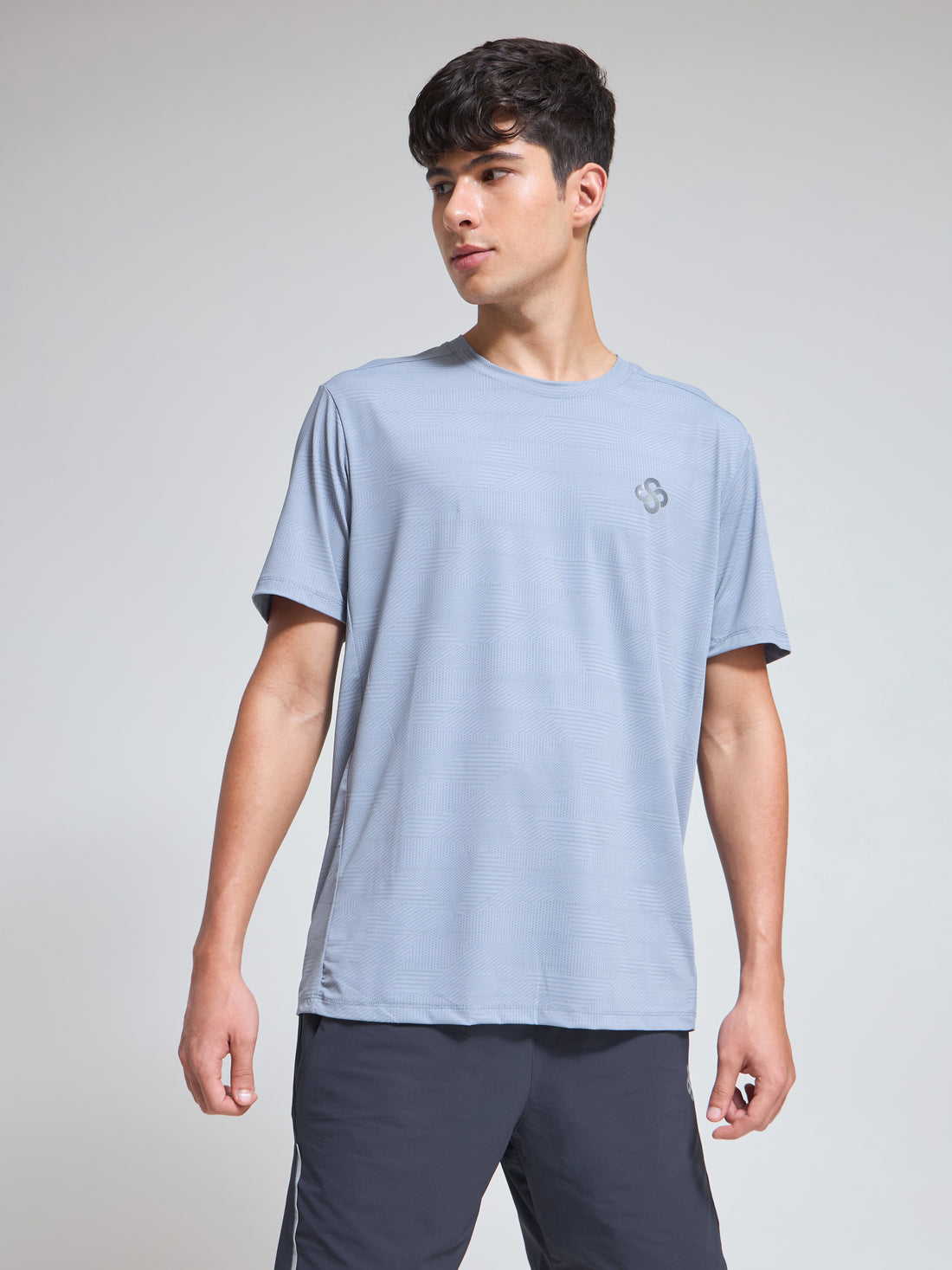 Man wearing Infinito’s sweat-wicking, lightweight performance tee engineered for everyday comfort and active movement