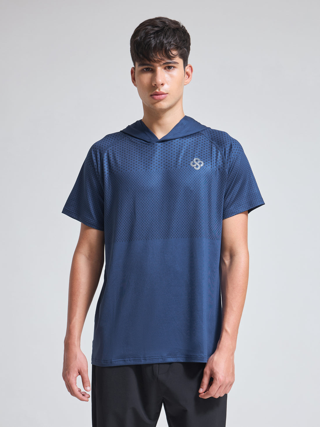 Man wearing Infinito’s SportTec Hoodie T-Shirt, a breathable hybrid workout tee designed for all-weather performance and street-to-gym versatility