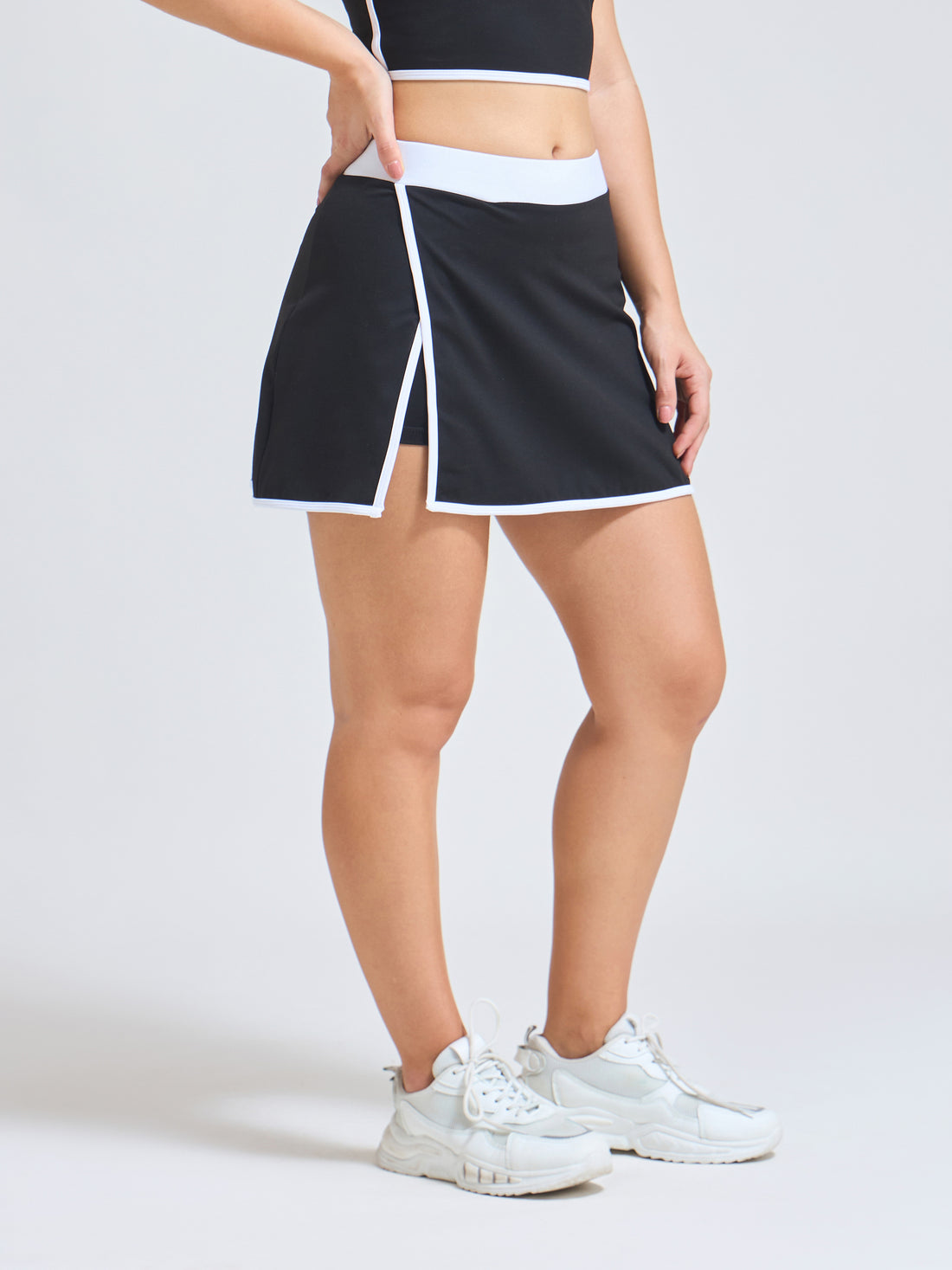 Woman wearing Infinito’s Flexiwear Wrapped Luxury Skirt, designed with a high-stretch inner short and sleek active wrap overlay