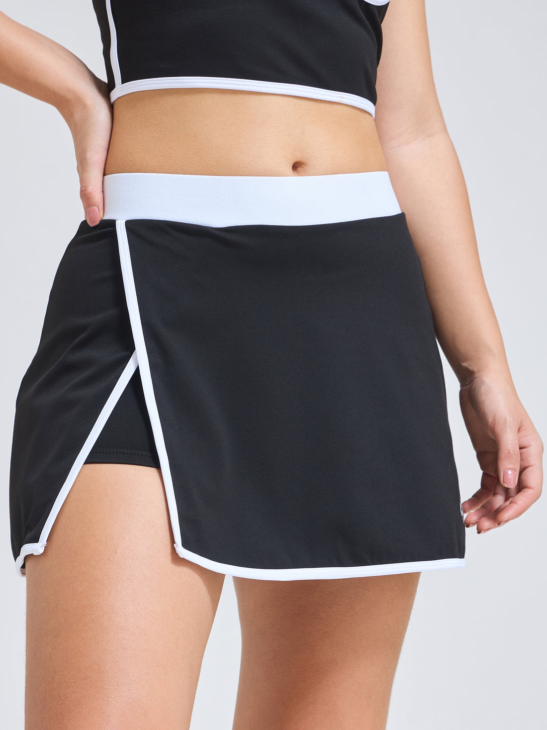 Woman wearing Infinito’s Flexiwear Wrapped Luxury Skirt, designed with a high-stretch inner short and sleek active wrap overlay