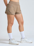 Woman wearing Infinito’s CoolShield UV Shorts in mint green, designed for sun protection, airflow, and high-performance comfort in warm weather