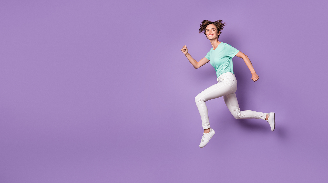 Woman in motion against a purple background, symbolizing energy, growth, and innovation in activewear